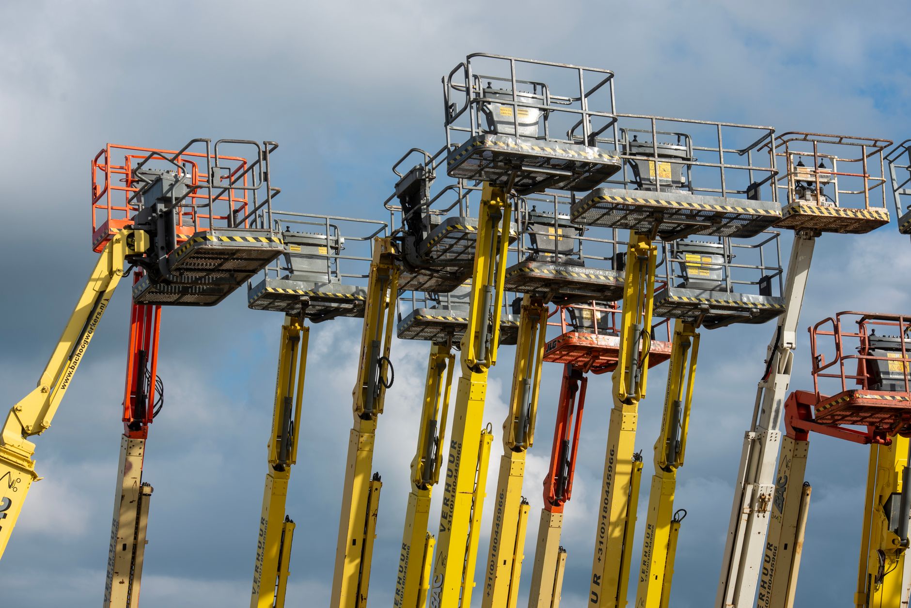 En skyltlift i arbete vid en fasad, där underlaget och vindförhållanden är avgörande för säkerheten.